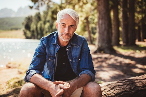 hiking man sitting outdoors after venaseal varicose vein treatment california